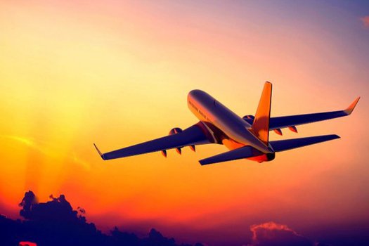 Aircraft climbing against a sunset sky