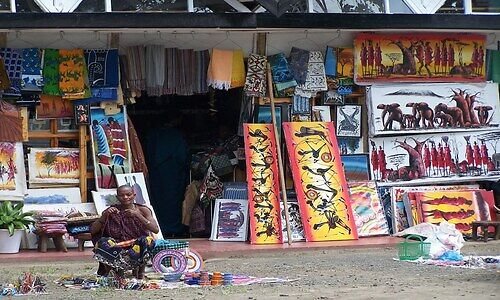 Curio stalls selling paintings and carvings at an Arusha craft market
